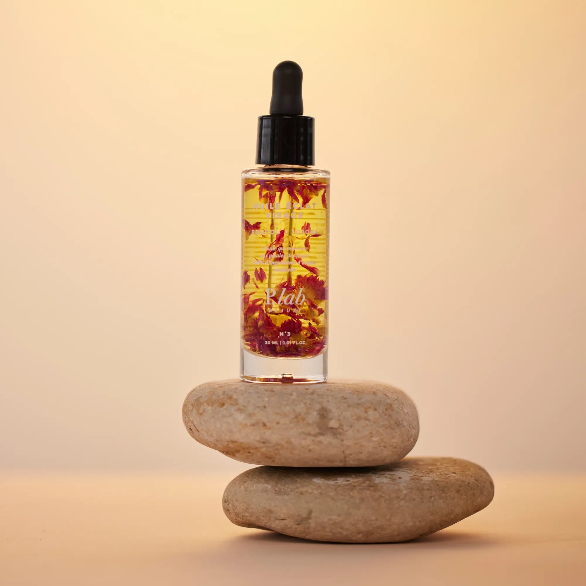 huile visage sur galet fond orange